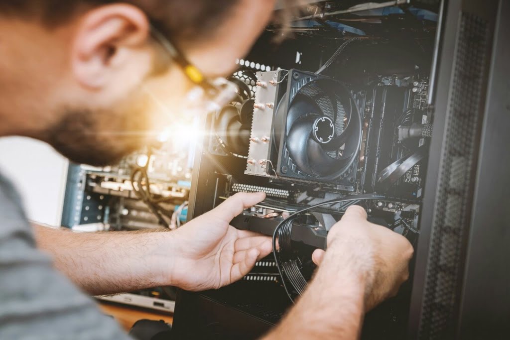 Man Assembling Parts of the System Unit